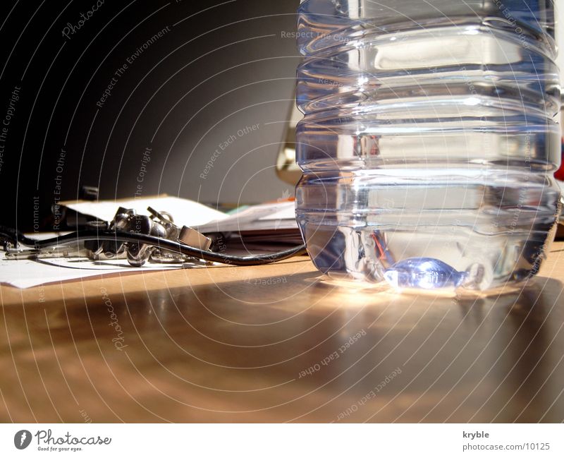 Wasserflasche Mineralwasserflasche Tisch Müll Licht glänzend Flasche volvic Schreibtisch müllig Lampe reflektion Glätte Schatten schatteneinfall