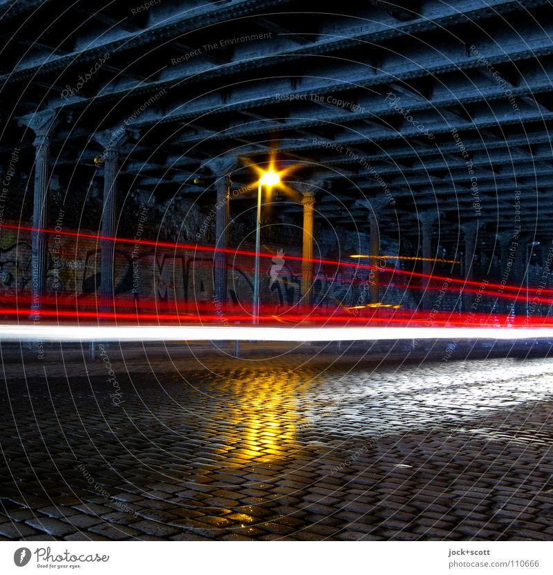 Velocitas im Tunnel Stahlträger Verkehrswege Straße Kopfsteinpflaster Straßenbeleuchtung Leuchtspur Graffiti dunkel historisch Geschwindigkeit Stimmung