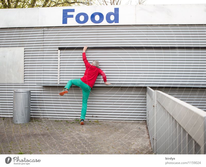 Mann in buntem Outfit besteigt einen Schnellimbiss mit der Aufschrift " FOOD " Ernährung Junger Mann Appetit & Hunger Erwachsene 1 Mensch 30-45 Jahre