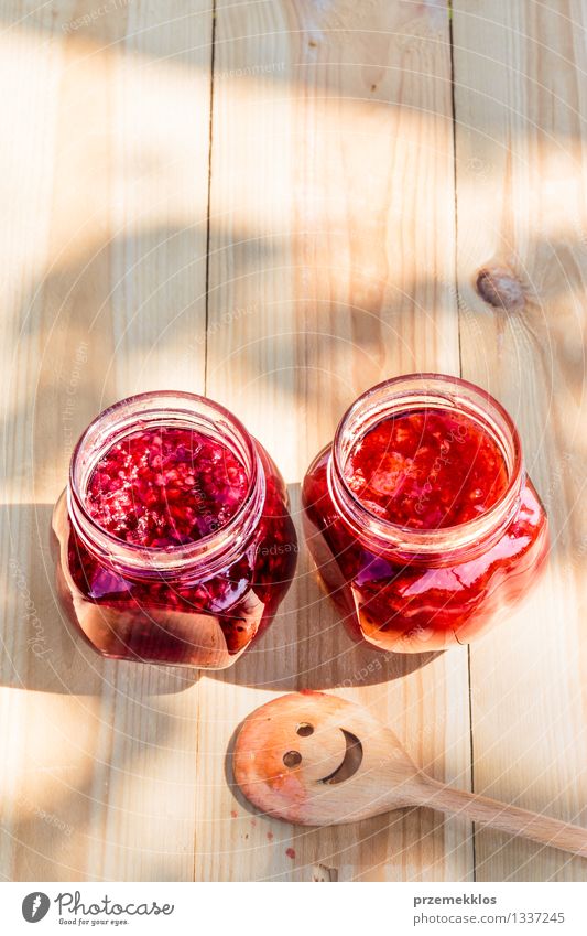 Hausgemachte Marmelade auf Holztisch Frucht Ernährung Frühstück Bioprodukte Löffel Sommer Tisch Natur frisch lecker natürlich rot Tradition Lebensmittel Glas
