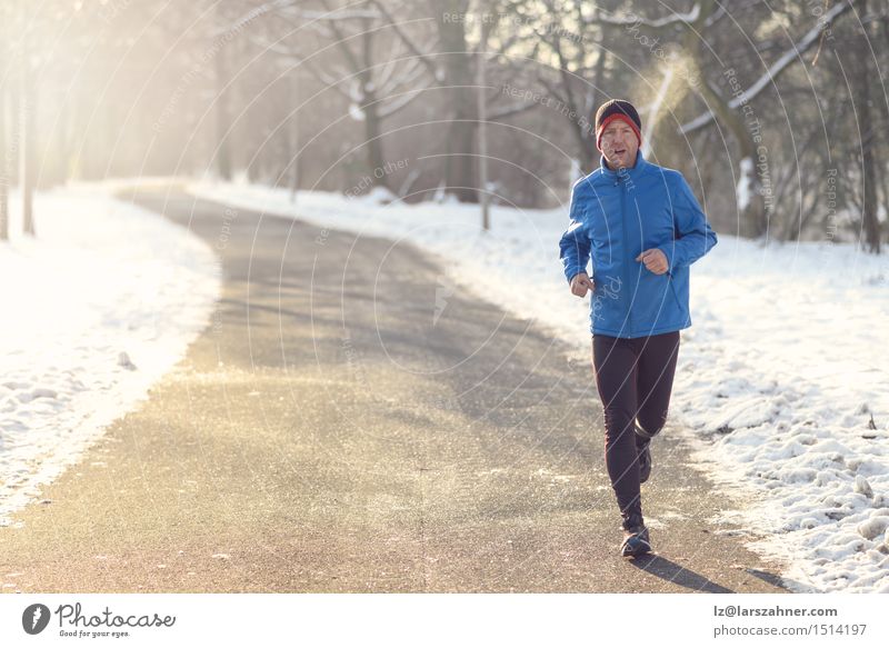 Mann, der in der Winterkleidung rüttelt Lifestyle Gesicht Schnee Sport Joggen Erwachsene 30-45 Jahre Zeitung Zeitschrift Park Straße atmen Fitness Tatkraft
