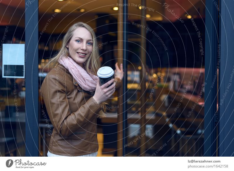 Junge blonde Frau, die eine Kaffee-Bar verlässt Getränk trinken Winter Restaurant Erwachsene 1 Mensch 18-30 Jahre Jugendliche Jacke Leder Schal gehen Lächeln