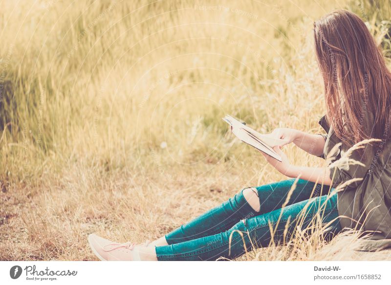 Frau liest draußen im Freien ein Buch buch lesen mädchen junge Frau lernen Wissen klug anonym