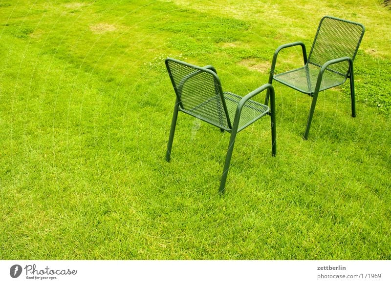 Zwei Stühle grün Rasen Sportrasen Wiese Park Gras Stuhl Gartenstuhl gartenmöbel Sitzung Verabredung Gegenüberstellung Kommunizieren Gesprächspartner gegenüber