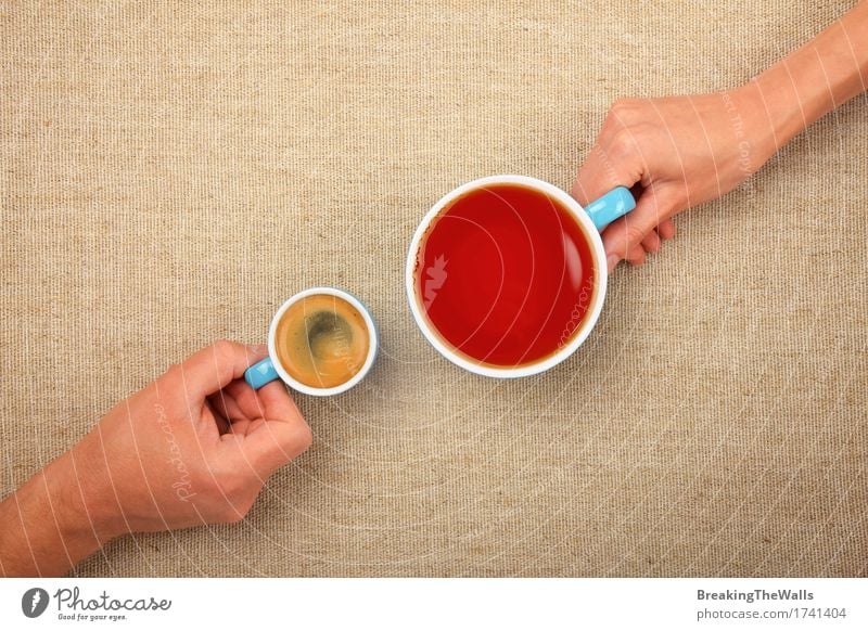 Zwei Hände, die volle Schalen Espressokaffee und schwarzen Tee halten Kaffeetrinken Getränk Heißgetränk Becher Frau Erwachsene Mann Hand festhalten Zusammensein