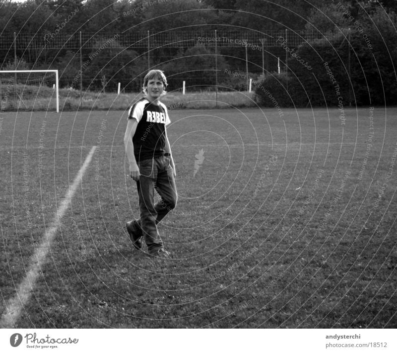 REBEL Fußballplatz Wiese stehen blond Mann rebel T-Shirt Schwarzweißfoto Coolness Tor Schilder & Markierungen verkreuzte beine