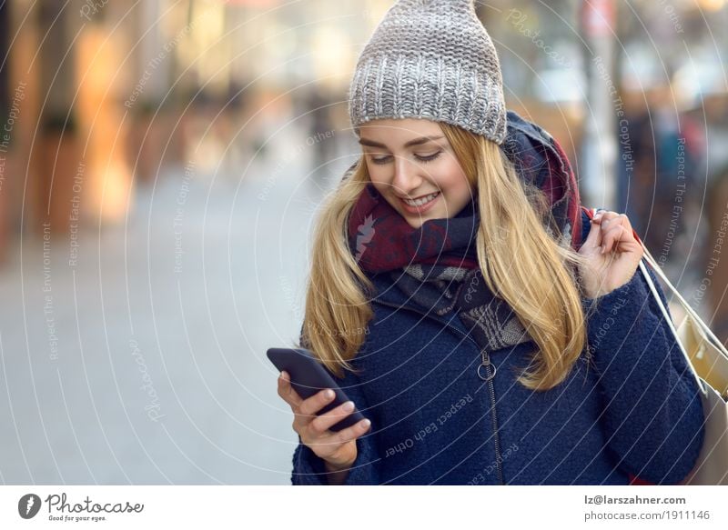 Moderne junge Frau beschäftigt mit ihrem Handy Lifestyle schön lesen Winter Telefon PDA Technik & Technologie Erwachsene 1 Mensch 18-30 Jahre Jugendliche Stadt
