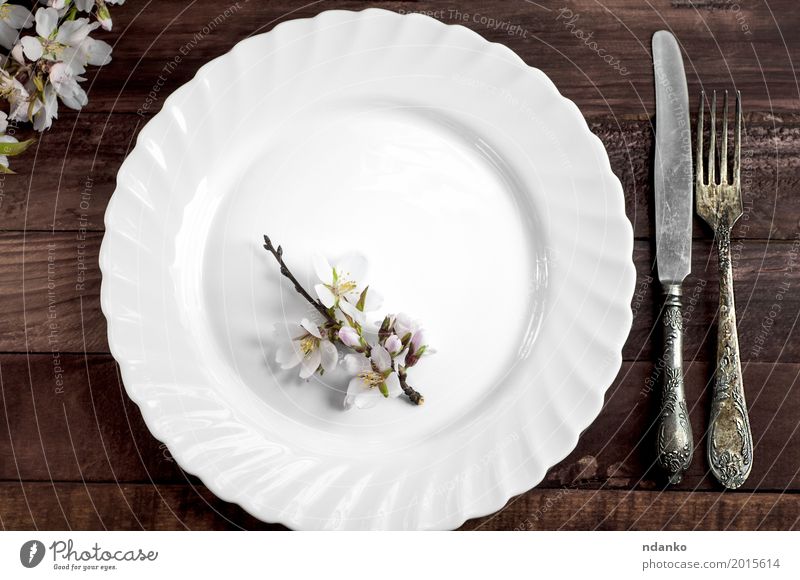 Weißer Teller mit Eisenbesteck Mittagessen Abendessen Besteck Messer Gabel Tisch Küche Restaurant Blume Platz Holz Metall Stahl alt oben retro braun weiß Speise