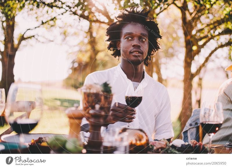 Afroamerikanischer Mann genießt Wein auf der Mittagsparty Lebensmittel Mittagessen Abendessen Getränk trinken Alkohol Sommer Garten Tisch Mensch maskulin