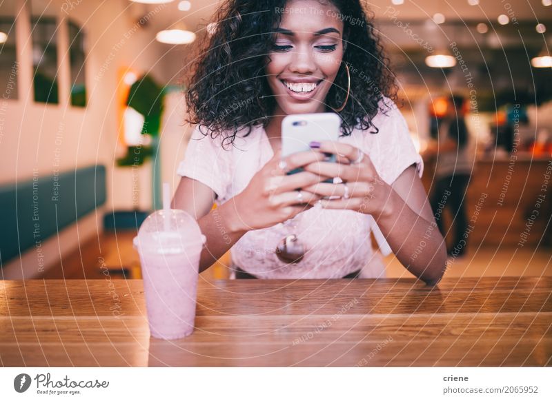 Lächelnde Frau, die Mitteilung auf Smartphone in der Bar schreibt Getränk trinken Lifestyle Freude Restaurant PDA Technik & Technologie Internet Jugendliche