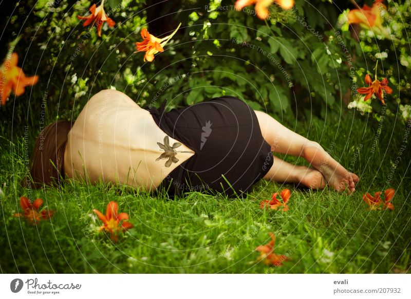Bloom again Mensch feminin Frau Erwachsene Körper Rücken Fuß 1 Sommer Blume Gras Garten Park liegen grün authentisch orange Tattoo Farbfoto Außenaufnahme Tag