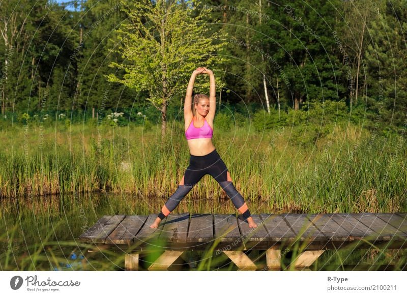 A sporty woman doing yoga and stretching exercises Lifestyle Wellness Sport Yoga Mensch Frau Erwachsene Natur Park Mode blond Fitness Aerobics active athlete
