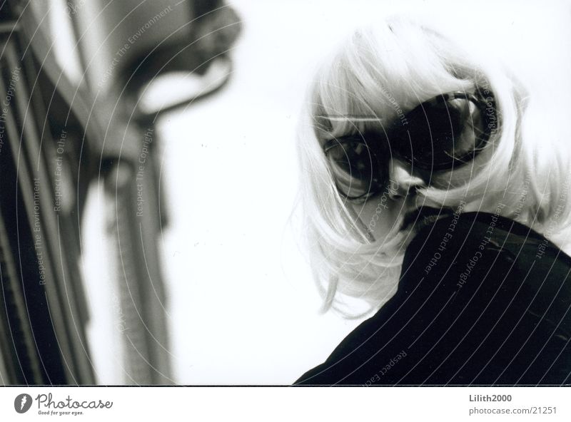 Blondie 1 Frau blond Perücke feminin Sonnenbrille Fassade Schwarzweißfoto