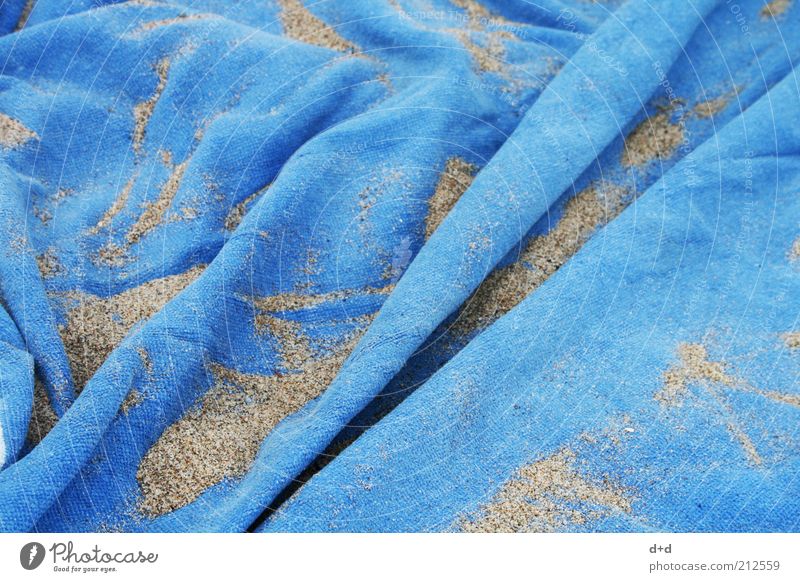 // Strand Handtuch blau Stoff Sand Faltenwurf Ferien & Urlaub & Reisen Urlaubsstimmung Badetuch Badeurlaub hell-blau Sandkorn Außenaufnahme Menschenleer