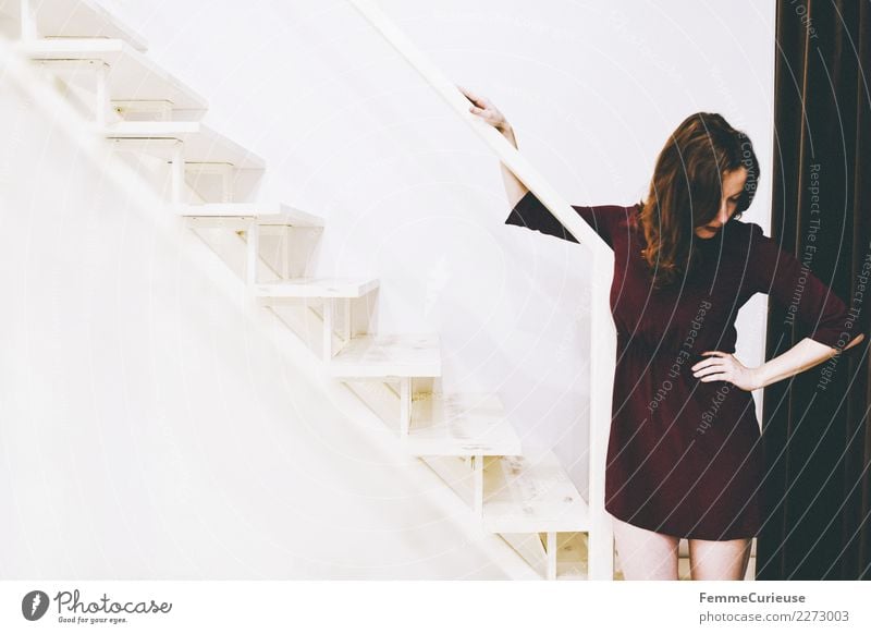 Woman in burgundy dress standing right on stairs feminin Junge Frau Jugendliche Erwachsene 1 Mensch 18-30 Jahre Gefühle Krise Schmerz In sich gekehrt
