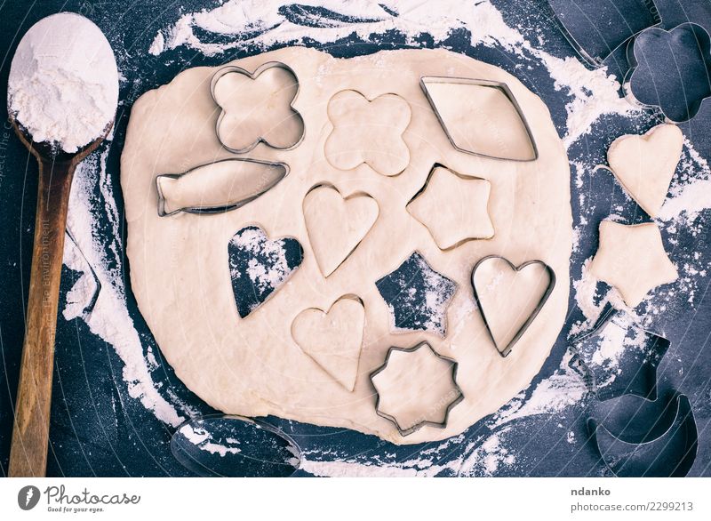 Plätzchen vom Teig herausschneiden Teigwaren Backwaren Süßwaren Löffel Tisch Küche Herz frisch oben schwarz weiß Stern Top gebastelt Hintergrund Lebensmittel