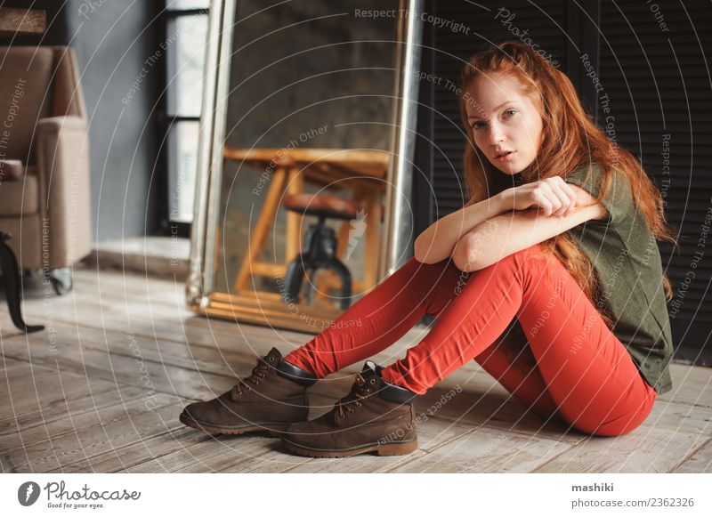 Innenporträt der schönen jungen rothaarigen Frau Lifestyle Stil Erholung Erwachsene Jugendliche Mode Stiefel Holz Metall dunkel modern weich grau Fürsorge