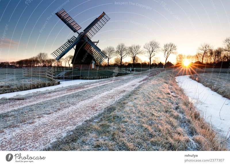 winterlicher Sonnenaufgang über gefrorener Landschaft mit Windmühle, Holland Winter Schnee Himmel Sonnenuntergang Wetter Eis Frost Fluss Gebäude Architektur