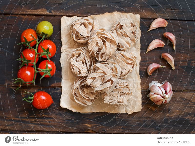 Vollkornnudeln mit Tagliatelle, Tomaten und Knoblauch Vegetarische Ernährung Diät Tisch dunkel frisch braun rot Tradition Essen zubereiten Lebensmittel