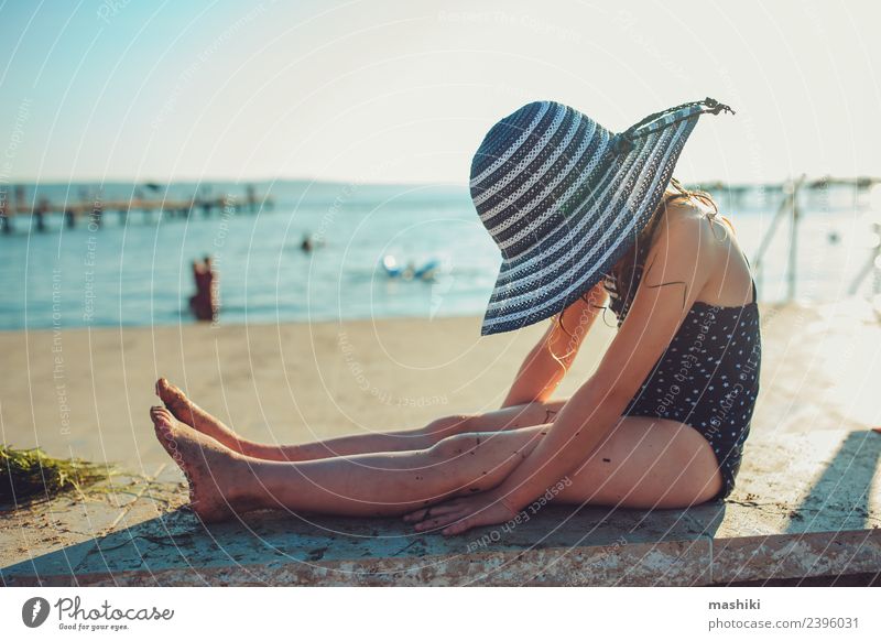 Kind entspannt sich am Sommerstrand Lifestyle Freude Erholung Ferien & Urlaub & Reisen Sonne Strand Meer Kindheit Hand Wärme Küste Hut Streifen genießen nass