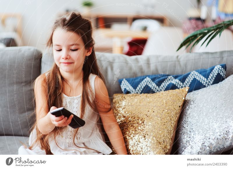 Kind Mädchen beim Fernsehen zu Hause Stil Freude Glück Erholung Wohnzimmer Schule Technik & Technologie beobachten sitzen klein modern Geborgenheit Einsamkeit