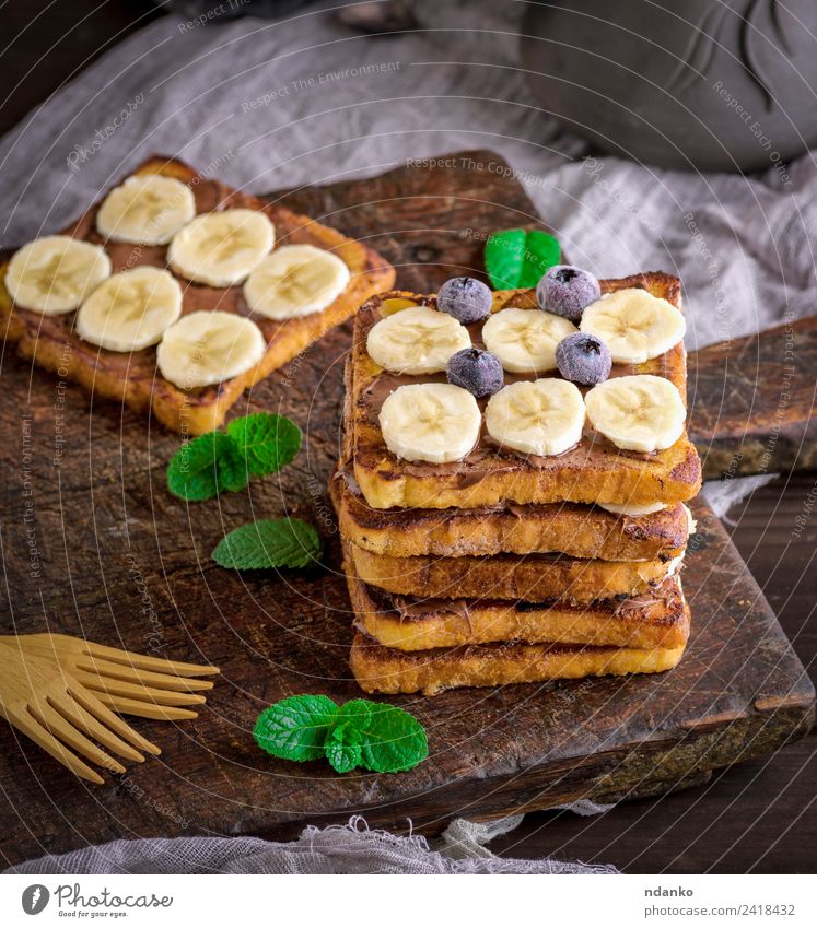 Französischer Toast auf das Frühstück Frucht Brot Dessert Süßwaren Ernährung Gabel Holz Essen frisch lecker oben Tradition Zuprosten Banane Schokolade