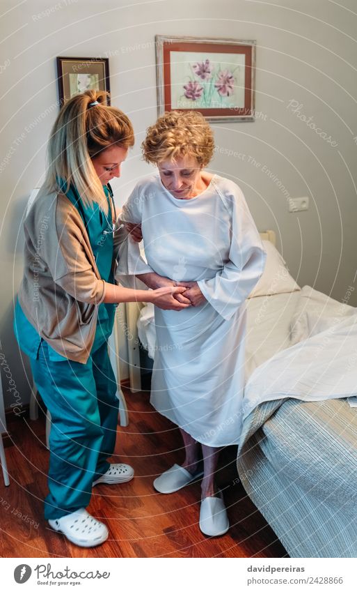 Betreuerin hilft älteren Patienten beim Aufstehen Lifestyle Gesundheitswesen Krankheit Medikament Arzt Krankenhaus Mensch Frau Erwachsene alt authentisch