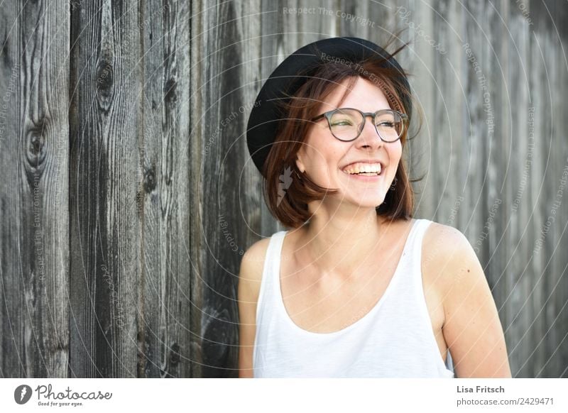 unbeschwert feminin Junge Frau Jugendliche 1 Mensch 18-30 Jahre Erwachsene Mauer Wand Brille Hut brünett kurzhaarig Holz lachen ästhetisch frei Fröhlichkeit