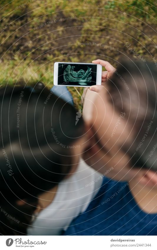 Schwanger aussehender Ultraschall auf dem Handy mit ihrem Mann Lifestyle Leben Feste & Feiern PDA Technik & Technologie Mensch Baby Frau Erwachsene Eltern