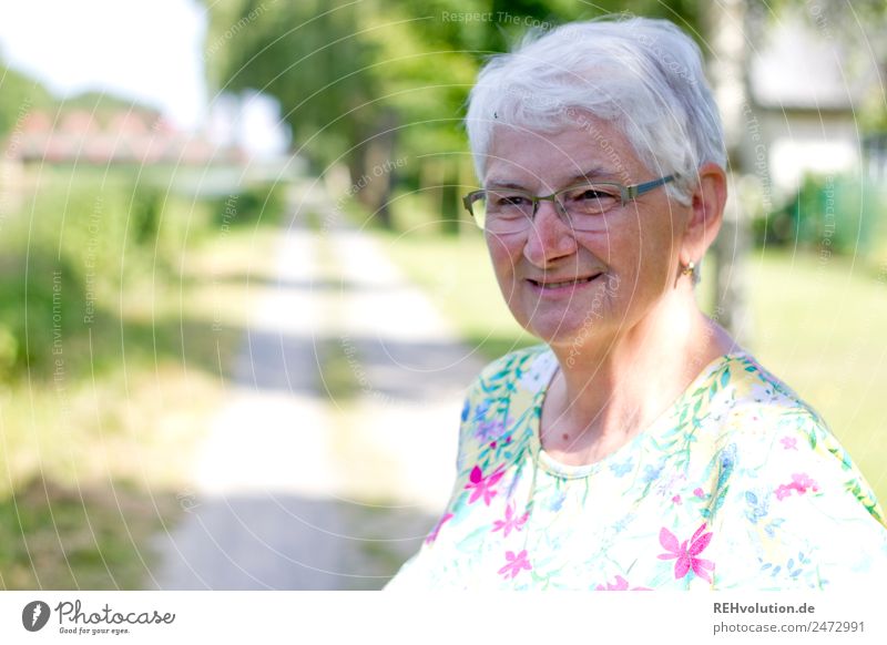 Seniorin lächelt Weiblicher Senior Frau 60 und älter Porträt alt Großmutter Natur Brille grauhaarig weißhaarig authentisch natürlich Außenaufnahme Landschaft