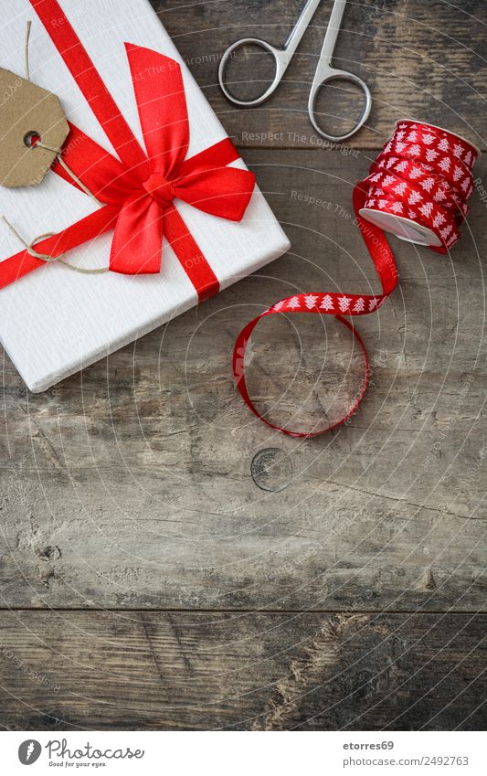 Weiße Geschenkbox auf Holzuntergrund. Weihnachten & Advent Verpackung Kasten Dekoration & Verzierung Souvenir Ornament rot weiß Schachtel