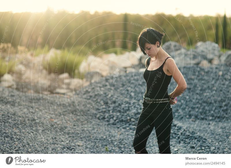 schönes Mädchen mit kurzem Haarschnitt und schwarzer Kleidung auf dem Land, das den Sonnenuntergang genießt attraktiv Hintergrund Atmung Kaukasier Tag träumend