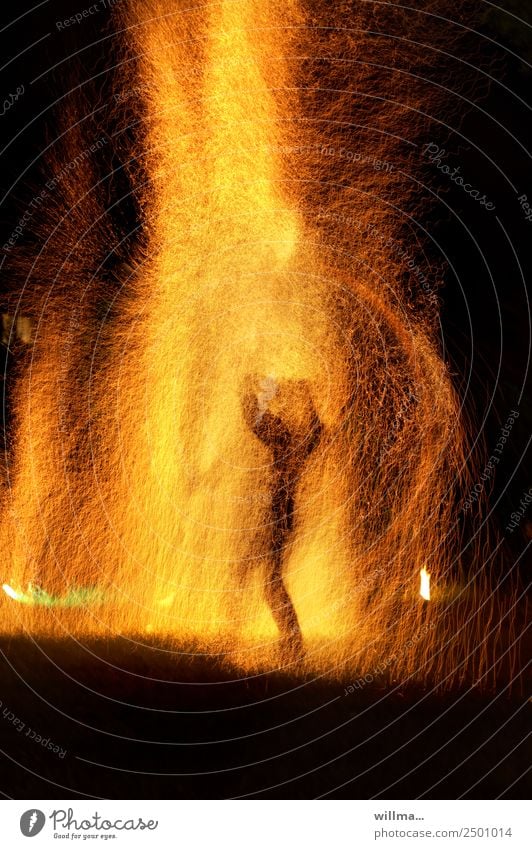 Mensch mitten im Feuer und Funkenregen Mutprobe bedrohlich brennen Brand Flamme Nacht Silhouette heiß Überleben Angst
