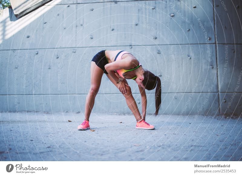 Passende Läuferin, die sich im Freien ausdehnt. Aktion Athlet muskulös schön Körper Großstadt üben Gesundheit sportlich Fitness Joggen Lifestyle Außenaufnahme