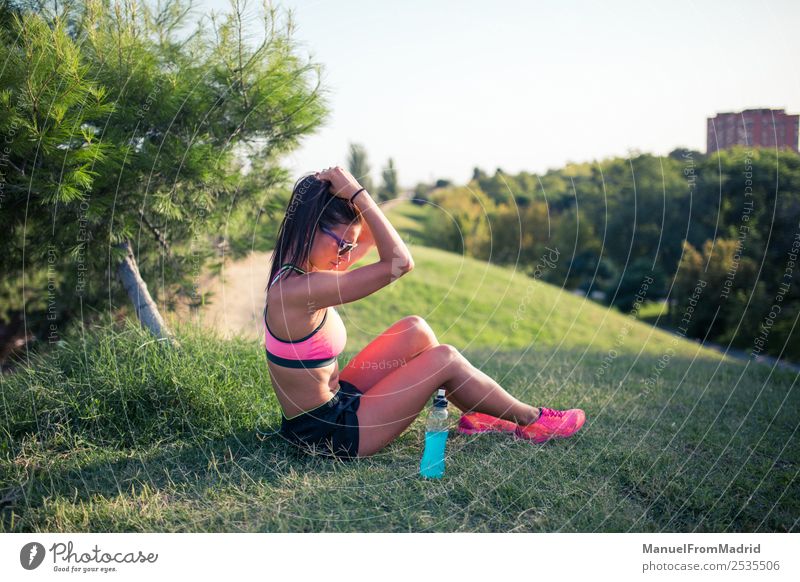 athletische Frau, die sich ausruht Flasche Lifestyle schön Sommer Sport Erwachsene Natur Park Fitness sitzen Energie Training Läufer aussruhen