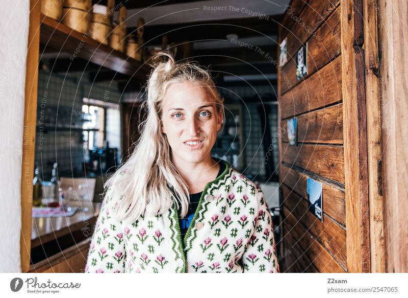 Junge Frau in Almhütte Stil feminin Jugendliche 18-30 Jahre Erwachsene Hütte Tracht Strickjacke blond langhaarig Arbeit & Erwerbstätigkeit Lächeln lachen