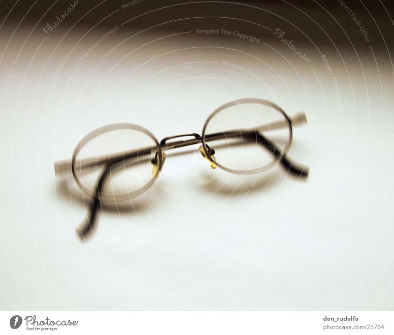 Brille vor Weiß Unschärfe bräunlich Monochrom graphisch Häusliches Leben Glas Schwarzweißfoto