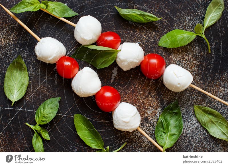 Italienischer Käse-Mozzarella mit Tomaten und Basilikum Ernährung Vegetarische Ernährung Ball dunkel frisch hell lecker weich grün rot weiß Tradition Mahlzeit