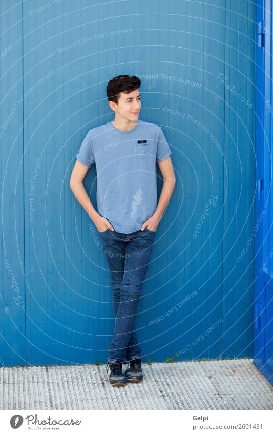 Porträt eines rebellischen Teenagers mit blauem Hintergrund Lifestyle Stil Glück schön Gesicht Mensch Junge Mann Erwachsene Jugendliche Mode Lächeln Coolness