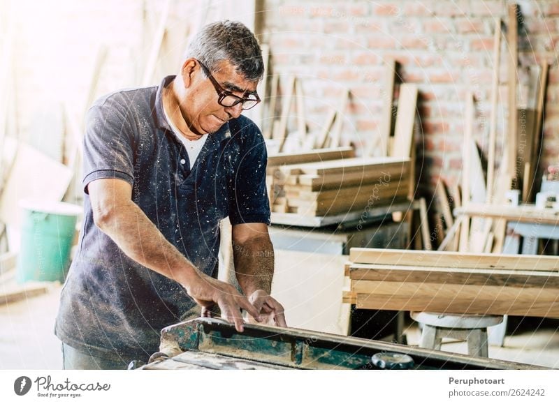 Schreiner schneidet Holzbrett in seiner Werkstatt. Schreibtisch Arbeit & Erwerbstätigkeit Industrie Handwerk Business Werkzeug Säge Mensch Mann Erwachsene