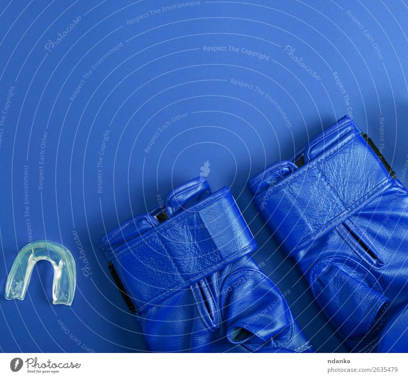 blaue Lederboxhandschuhe und Silikonkappe für die Zähne Stil Fitness Sport Handschuhe oben Schutz Farbe Idee Konkurrenz Kreativität Macht Aktion Hintergrund