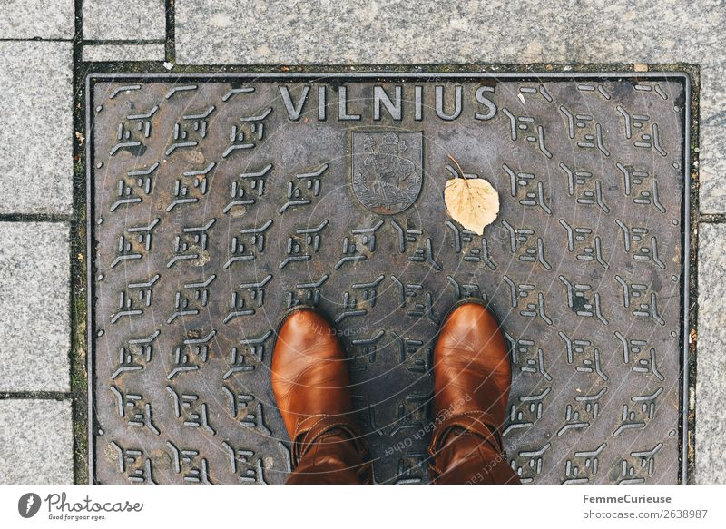 Person with brown boots standing on a manhole cover in Vilnius Lifestyle feminin Junge Frau Jugendliche Erwachsene 1 Mensch Ferien & Urlaub & Reisen Ausflug