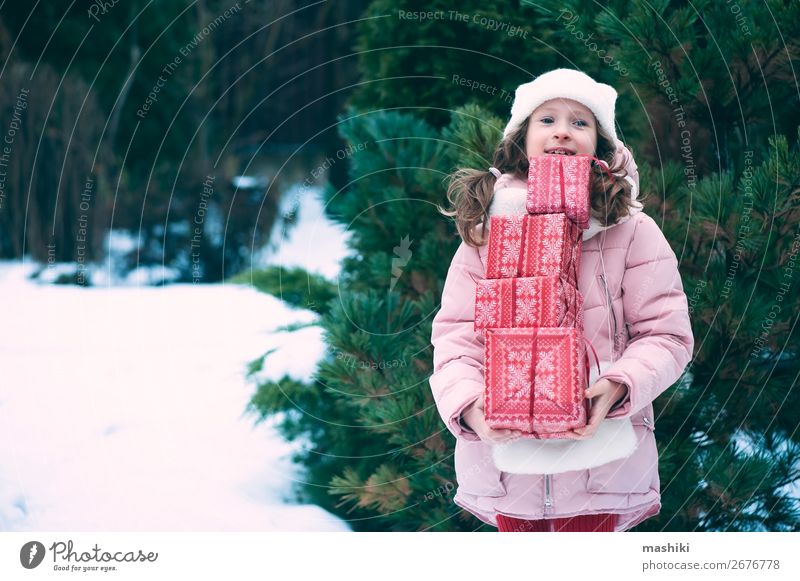 fröhliches Kind Mädchen spielt im Freien mit Weihnachtsgeschenken Lifestyle Freude Glück Spielen Ferien & Urlaub & Reisen Winter Schnee Feste & Feiern