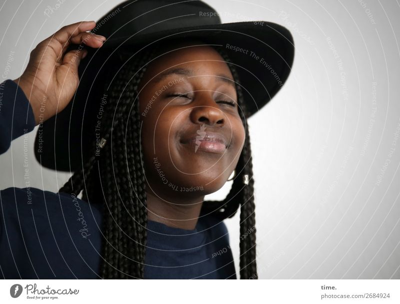 Gloria feminin Mädchen 1 Mensch Pullover Hut schwarzhaarig langhaarig Afro-Look Erholung festhalten genießen Lächeln träumen Fröhlichkeit lustig schön Freude