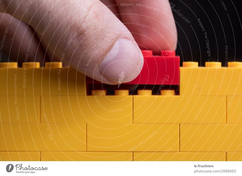 der fehlende Baustein Hausbau Baustelle Finger Mauer Wand Spielzeug Kunststoff wählen berühren festhalten eckig Zusammensein nachhaltig gelb rot Tatkraft
