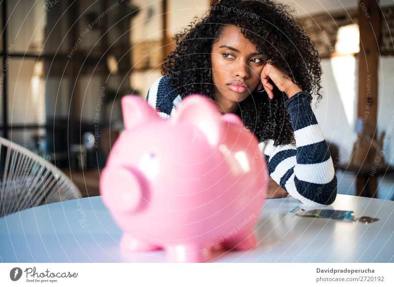 Traurig frustrierte schwarze Frau mit Sparschwein Spardose Schulden Krise Traurigkeit Haushaltsplan Wut beunruhigt Kapitalwirtschaft verärgert Stress Fürsorge