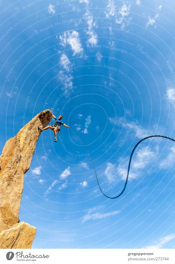 Der Kletterer baumelt vom Gipfel. Leben Abenteuer Klettern Bergsteigen Erfolg Seil maskulin Mann Erwachsene 1 Mensch Felsen hängen blau selbstbewußt Kraft