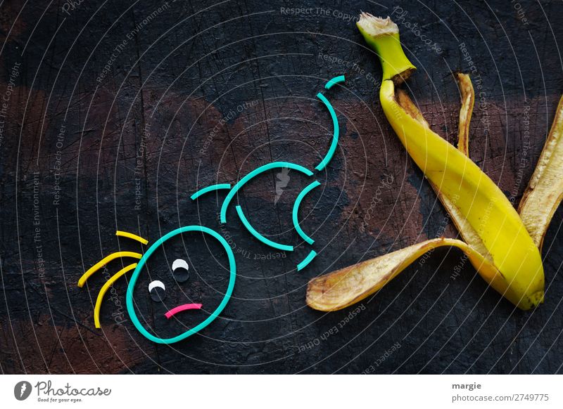 Gummiwürmer: Ausrutscher! Ein Mensch rutscht auf einer Banane aus Ernährung maskulin Frau Erwachsene Mann 1 braun gelb gefährlich Stress Ärger Frustration