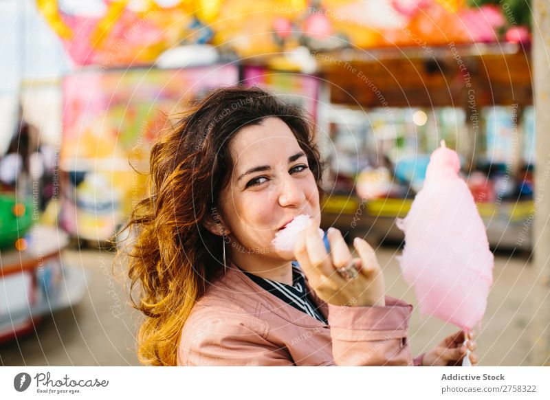 Frau mit Zuckerwatte im Park Kinderkarussell Person rosa hübsch süß Lebensmittel essen Spaß Lifestyle Porträt jung Lächeln Beteiligung Snack außerhalb weich