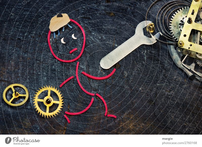 Gummiwürmer: Zeitumstellung. Ein Monteur dreht mit einem Schraubenschlüssel an einem Uhrwerk Werkzeug Zeitmaschine Messinstrument Technik & Technologie